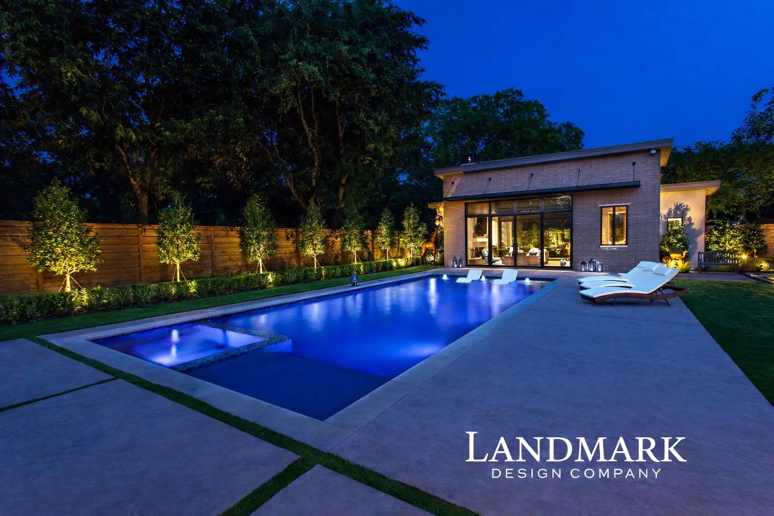 Modern home with a covered patio and outdoor living area beside a backyard pool