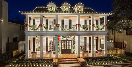 Two story house at night with christmas lights